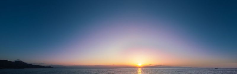 Scenic view of sea against clear sky during sunset