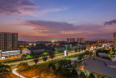 High angle view of illuminated cityscape against sky during sunset