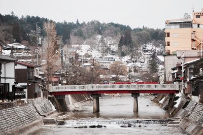 Train on bridge in city