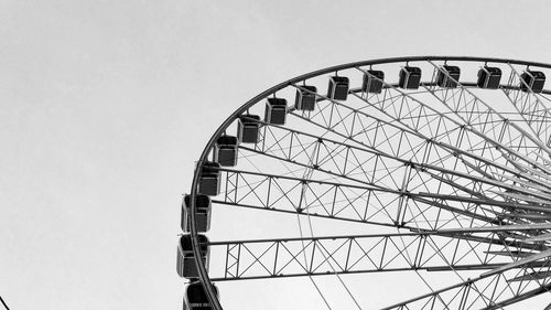 Low angle view of ferris wheel against clear sky