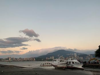 Boats in marina at sunset