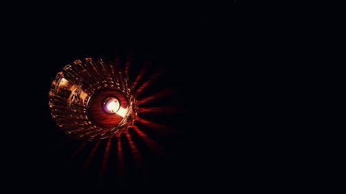 Low angle view of illuminated lighting equipment in darkroom