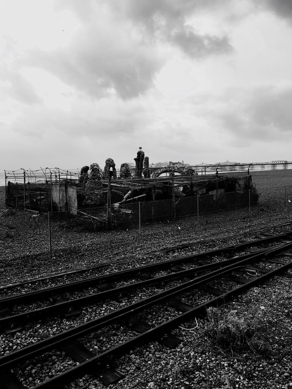 railroad track, rail transportation, sky, transportation, cloud - sky, field, public transportation, landscape, agriculture, rural scene, railway track, cloudy, train - vehicle, farm, cloud, day, no people, outdoors, metal, railroad station