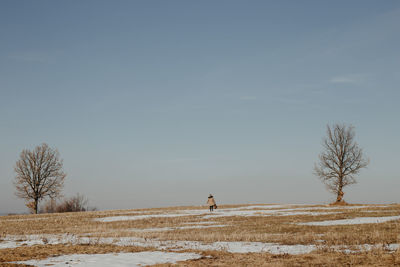 Scenic view of snowy field against sky