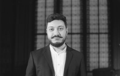 Portrait of bearded man standing indoors