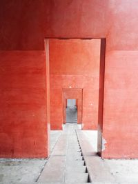 Narrow walkway along brick wall