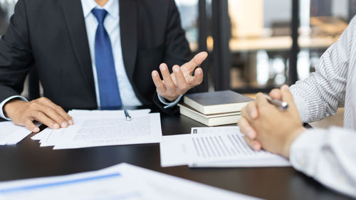 Midsection of business colleagues working at office