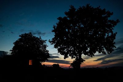 Low angle view of silhouette trees against sky at sunset