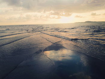 Scenic view of beach against sky during sunset