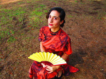 High angle view of teenage girl holding umbrella