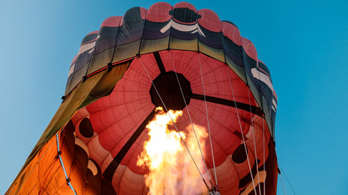 Low angle view of hot air balloon against blue sky