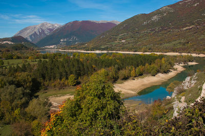 Scenic view of lake and mountains against sky