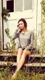 Portrait of young woman sitting outdoors