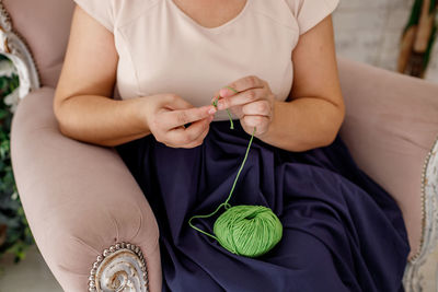 Midsection of woman holding stethoscope