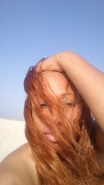 Close-up of woman against blue background