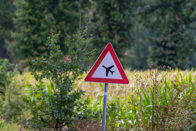 Road sign by trees