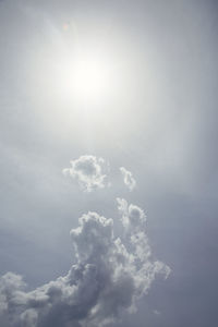 Low angle view of bright sun in sky