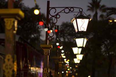 Low angle view of street lamps in city at night