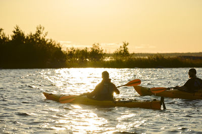 Men kayaking on sunny autumn day