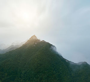 Scenic view of mountains against cloudy sky