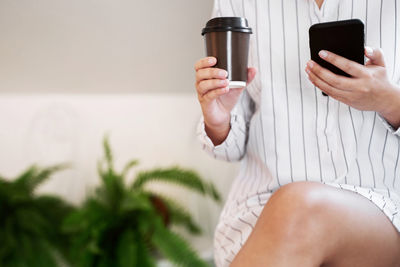 Midsection of man using mobile phone