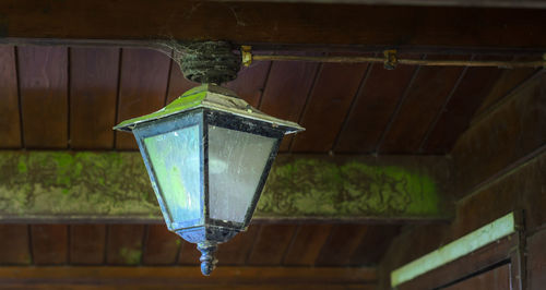 Low angle view of lantern hanging on roof