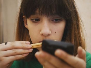 Close-up of girl using mobile phone