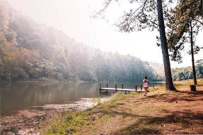 Man on lake against sky