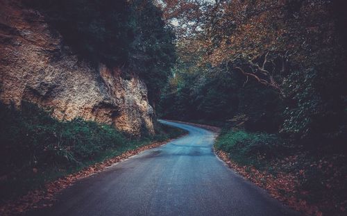 Empty road passing through tunnel