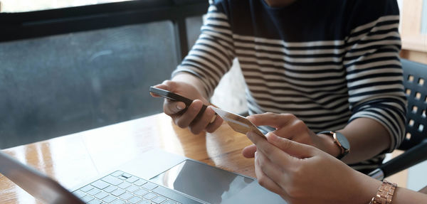 Midsection of woman using mobile phone