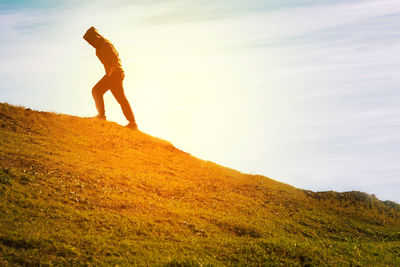 Low angle view of man against sky during sunset