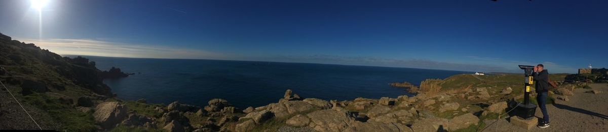 Panoramic view of sea against blue sky