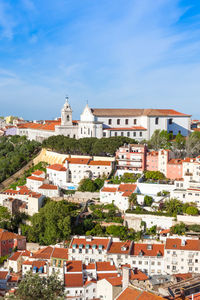 Buildings in city against blue sky