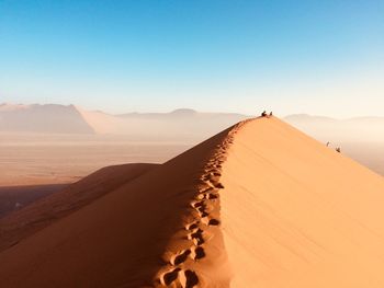 Scenic view of desert against clear sky