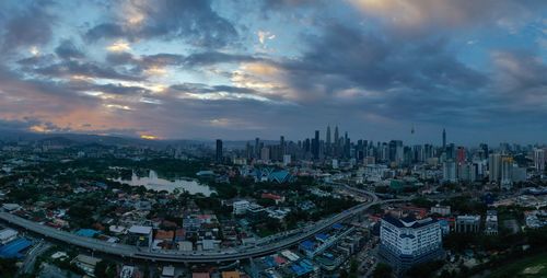 High angle view of modern buildings against sky during sunset