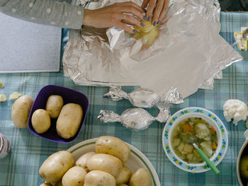 High angle view of woman with fruits on table