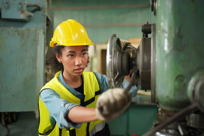 Portrait of boy standing in factory