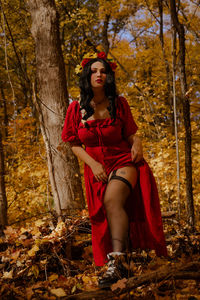 Young woman sitting in forest