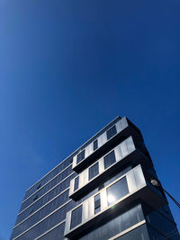 Low angle view of modern building against clear blue sky