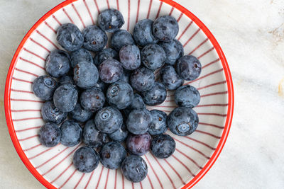 High angle view of blueberries in bowl on table