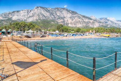 Scenic view of sea and mountains against sky