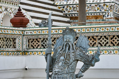 Statue of temple against building