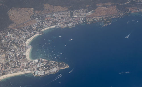 Aerial view of city by sea