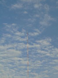 Low angle view of airplane flying against sky