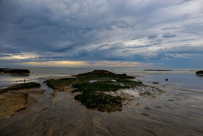 Scenic view of beach against sky during sunset