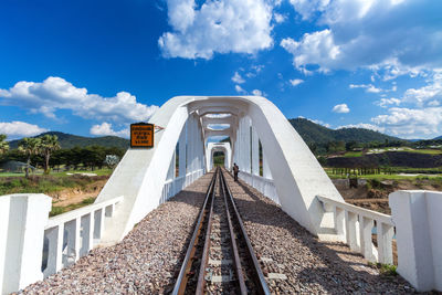 View of railroad tracks against cloudy sky