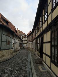 Street amidst buildings against sky