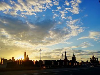 Silhouette of buildings against cloudy sky