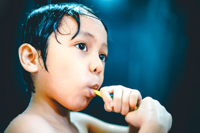 Cute boy brushing teeth