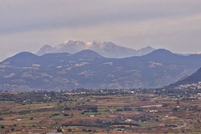 Scenic view of landscape and mountains against sky